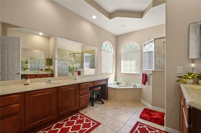 bathroom with tile patterned flooring, vanity, and separate shower and tub