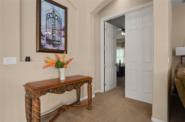 hallway featuring light colored carpet