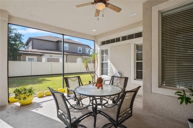 sunroom featuring ceiling fan