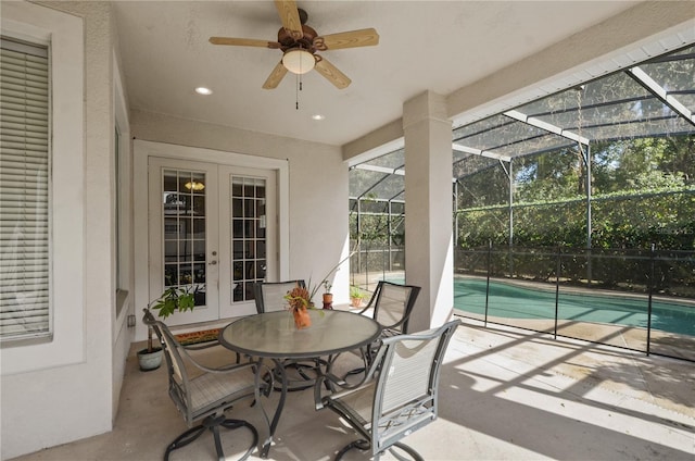 sunroom / solarium featuring a swimming pool, french doors, and ceiling fan