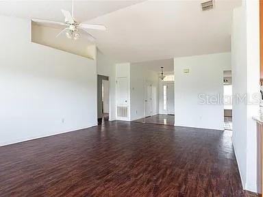 interior space featuring dark wood-type flooring and ceiling fan