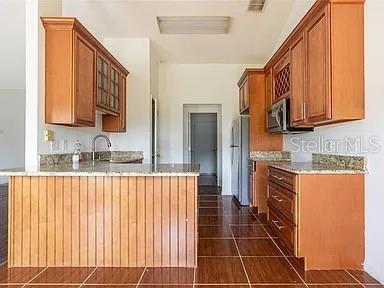 kitchen featuring fridge and kitchen peninsula