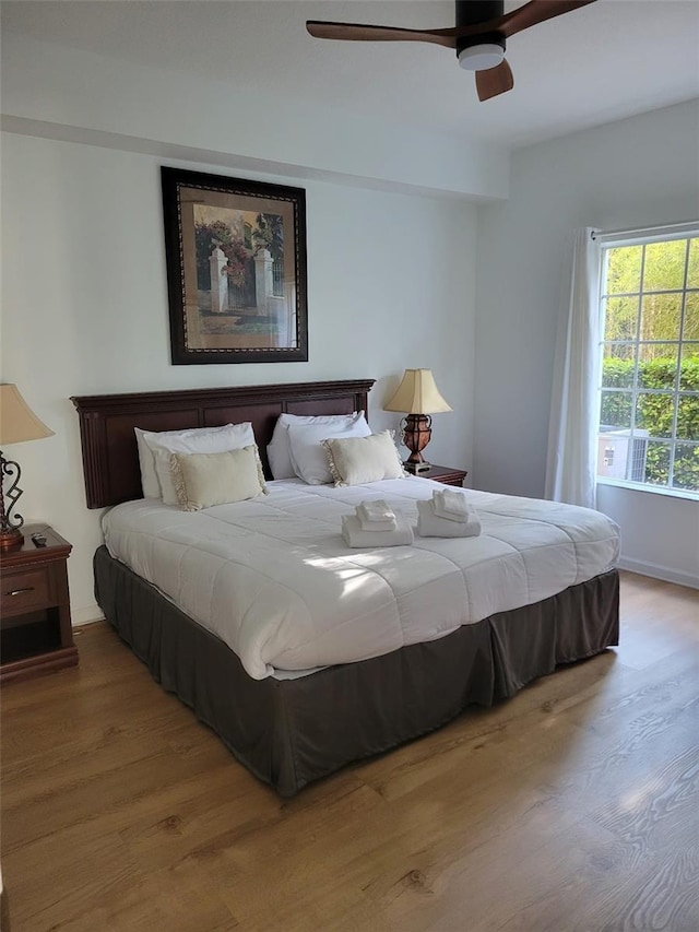 bedroom with light hardwood / wood-style floors and ceiling fan