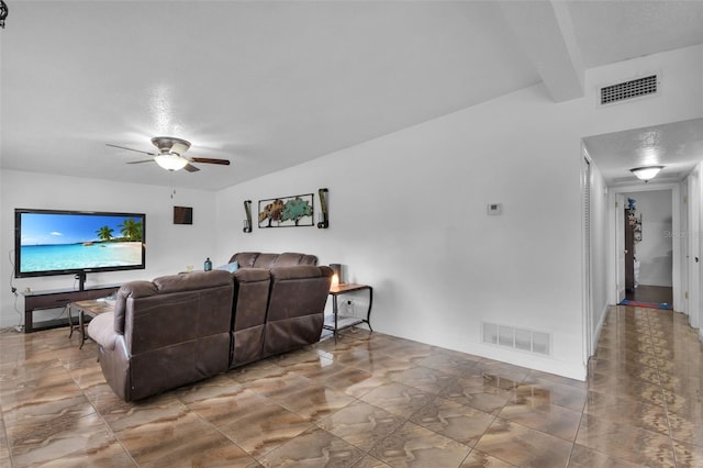 living room with ceiling fan and beam ceiling