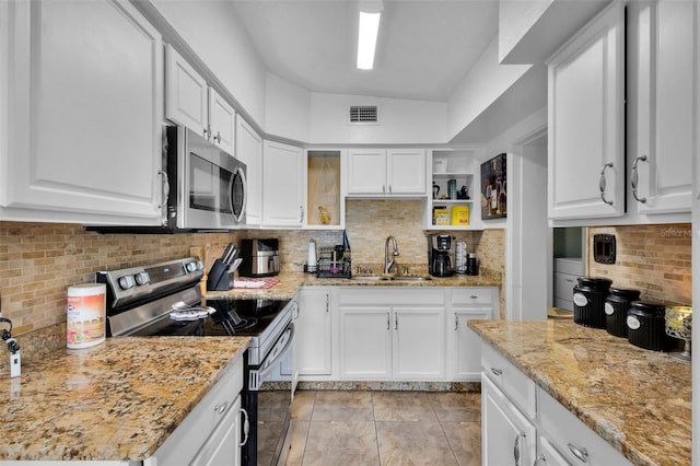 kitchen featuring white cabinetry, stainless steel appliances, sink, and light stone counters