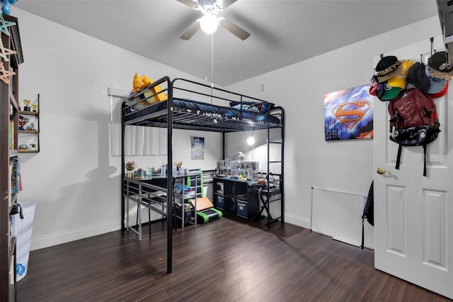 bedroom with dark hardwood / wood-style flooring and ceiling fan