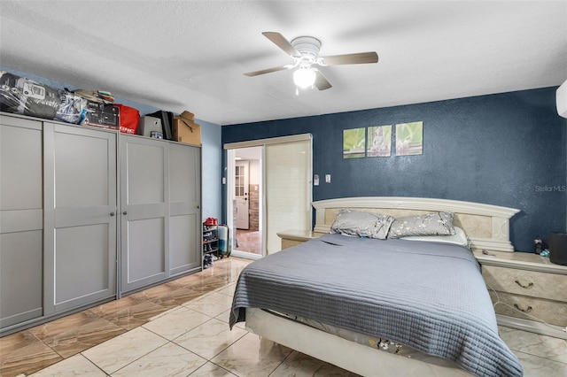 bedroom with a textured ceiling and ceiling fan