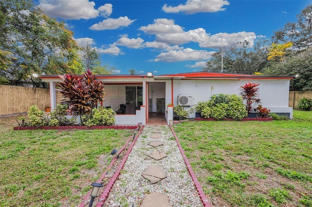 single story home featuring ac unit and a front yard