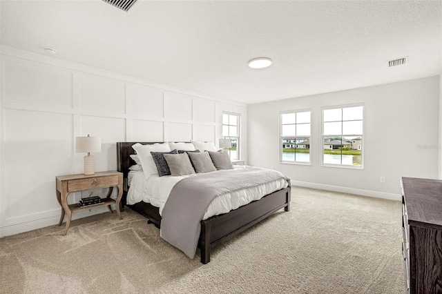 bedroom with carpet floors and a textured ceiling