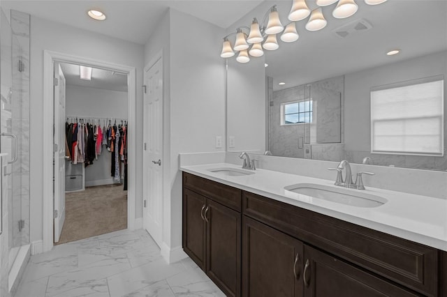 bathroom with vanity and a shower with shower door