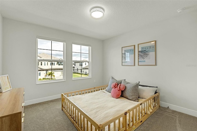 carpeted bedroom featuring a textured ceiling