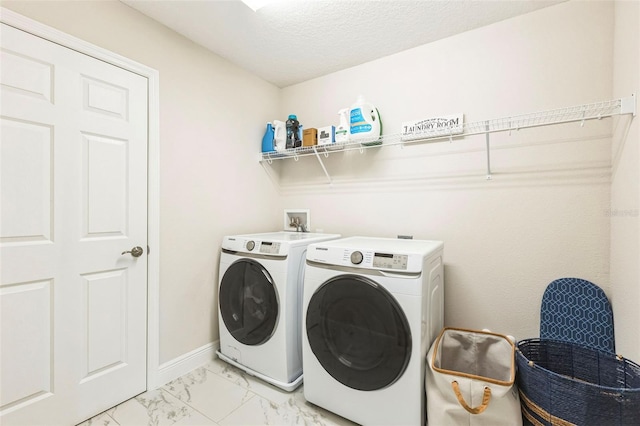 washroom featuring separate washer and dryer and a textured ceiling