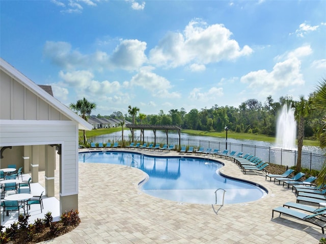 view of pool featuring a patio and a water view