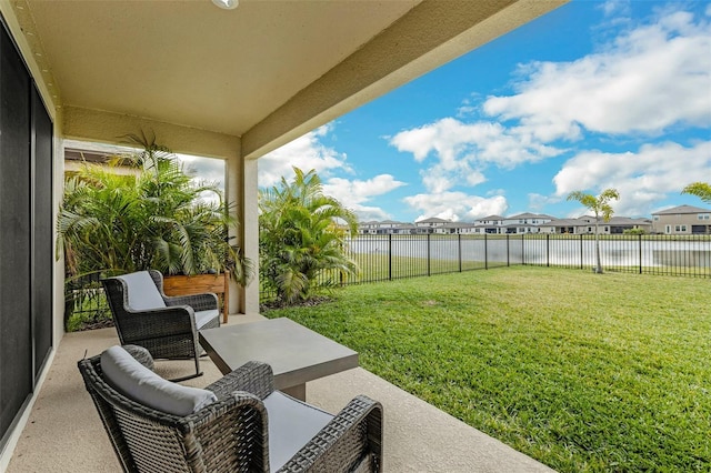 view of yard with a water view, a fenced backyard, and a residential view