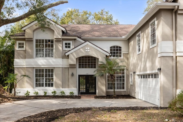 view of front of property with french doors and a garage