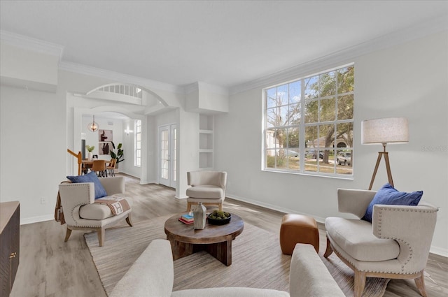 living room featuring crown molding, hardwood / wood-style floors, and french doors