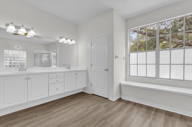 bathroom featuring an enclosed shower, hardwood / wood-style floors, vanity, and ceiling fan