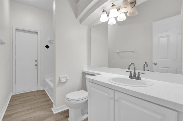 full bathroom featuring vanity, hardwood / wood-style floors, shower / washtub combination, and toilet