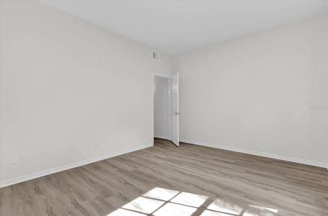 spare room with light wood-type flooring