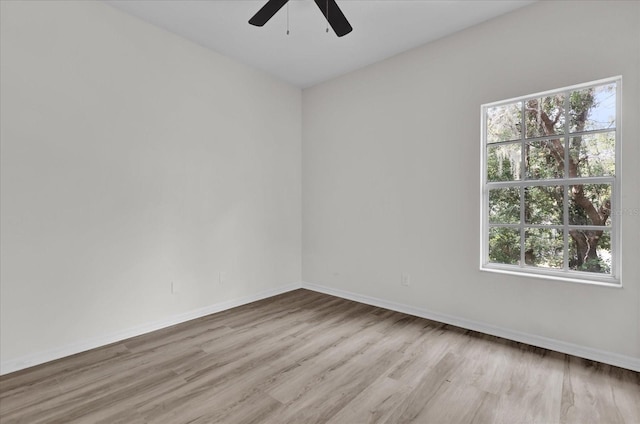 spare room featuring ceiling fan and light hardwood / wood-style flooring