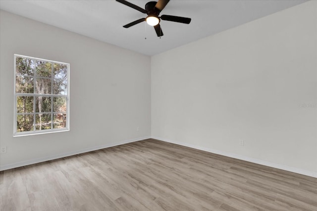 unfurnished room with plenty of natural light, ceiling fan, and light hardwood / wood-style flooring