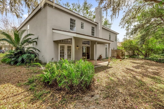 back of house with french doors and a patio area