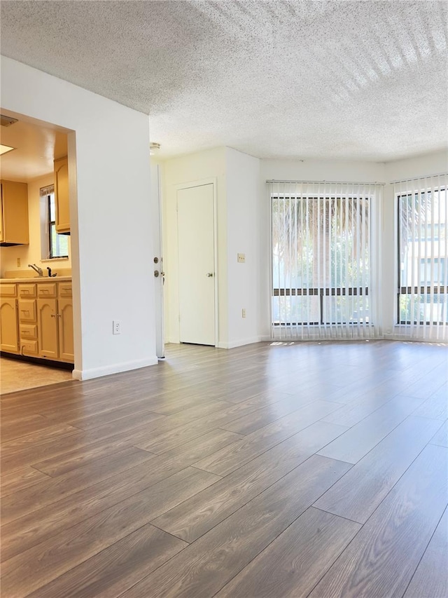 interior space with hardwood / wood-style floors and a textured ceiling