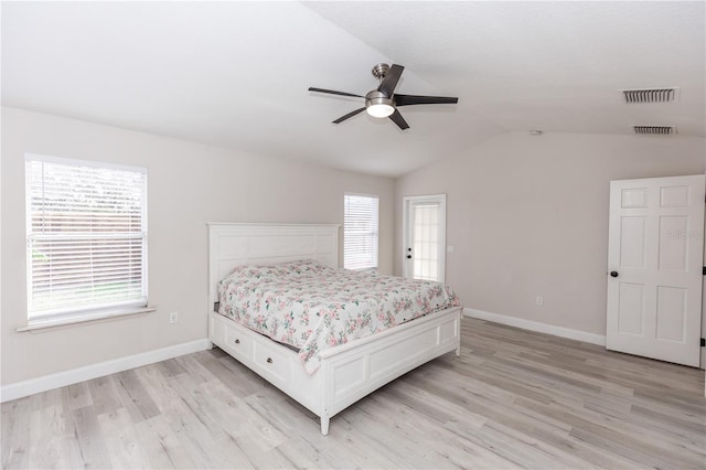 bedroom with vaulted ceiling, light hardwood / wood-style floors, and ceiling fan