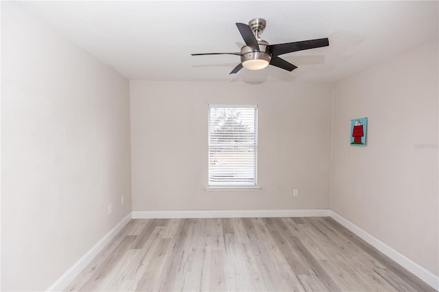 empty room with ceiling fan and light hardwood / wood-style flooring