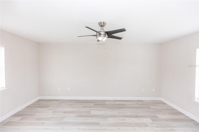 empty room featuring light hardwood / wood-style flooring, ceiling fan, and plenty of natural light