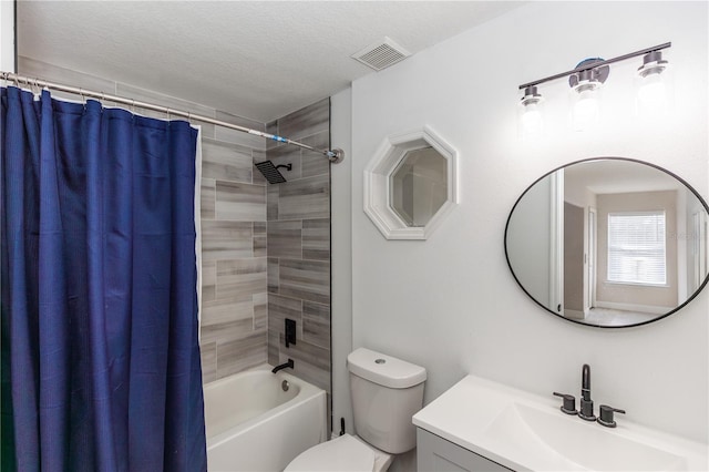 full bathroom with vanity, a textured ceiling, toilet, and shower / bath combo with shower curtain