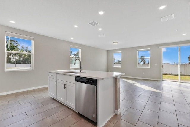 kitchen featuring sink, white cabinetry, dishwasher, an island with sink, and a healthy amount of sunlight