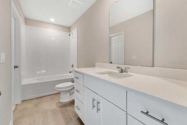 full bathroom featuring vanity, tiled shower / bath, and toilet