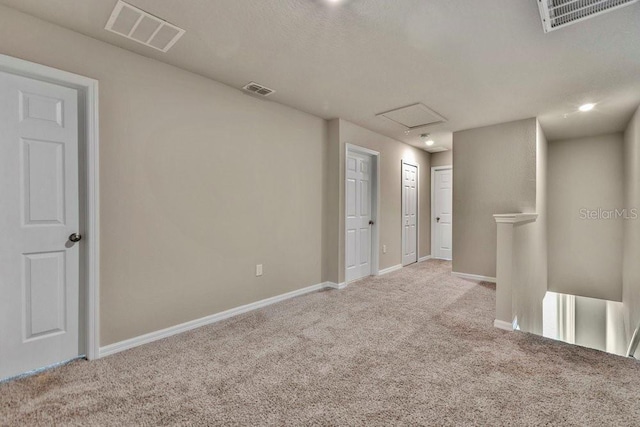 unfurnished room featuring light colored carpet