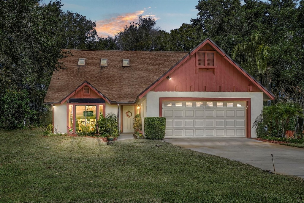 view of front of house with a garage and a lawn