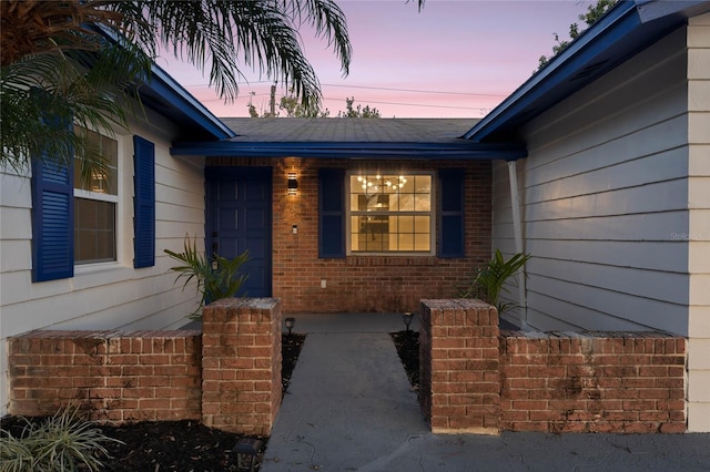 view of exterior entry at dusk