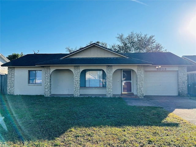 single story home with a garage and a front lawn