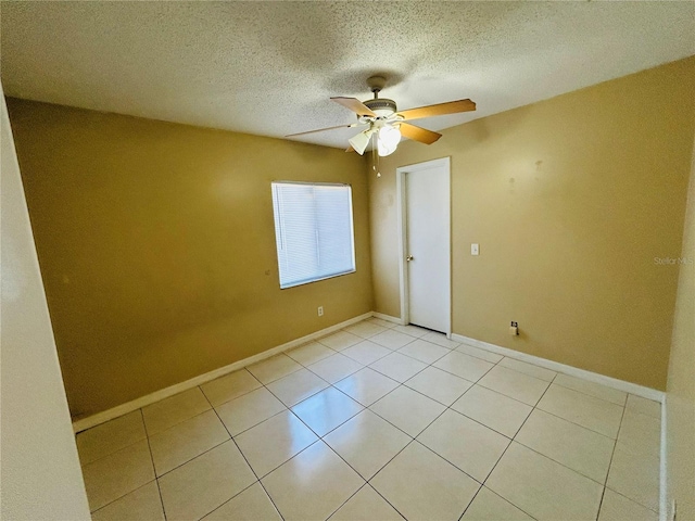 unfurnished room featuring light tile patterned flooring, ceiling fan, and a textured ceiling