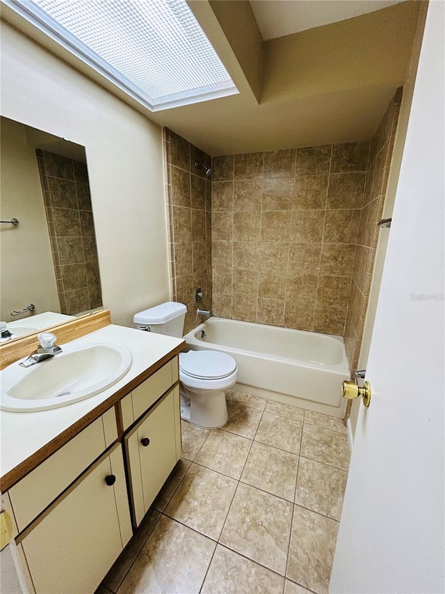 full bathroom featuring tile patterned flooring, vanity, tiled shower / bath combo, and toilet