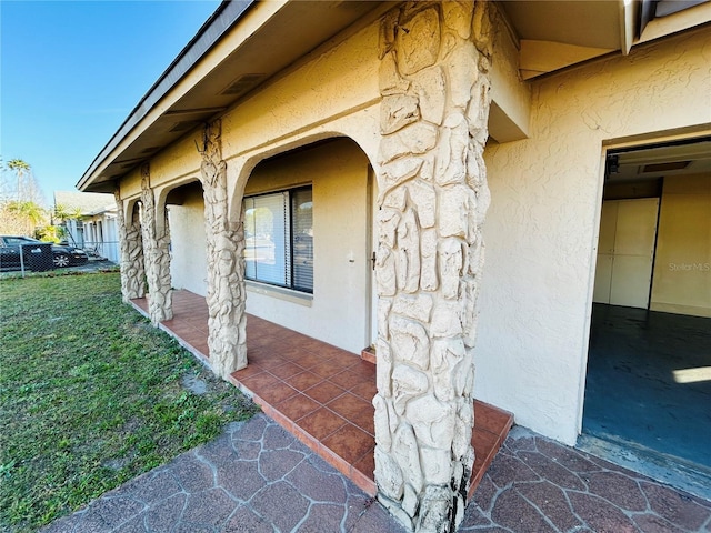 doorway to property with a yard