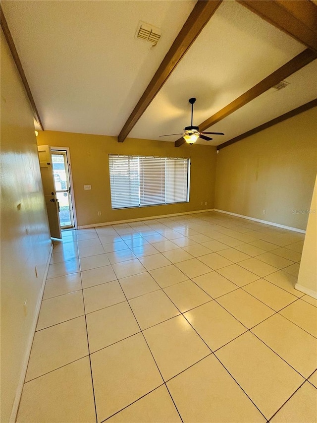 spare room with lofted ceiling with beams, light tile patterned floors, and ceiling fan