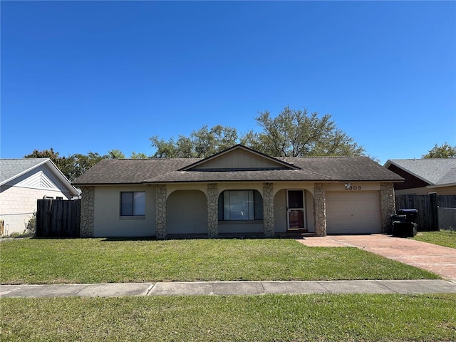 single story home with a garage, driveway, a front yard, and fence