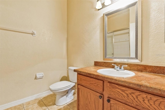 bathroom featuring tile patterned floors, toilet, vanity, and a shower