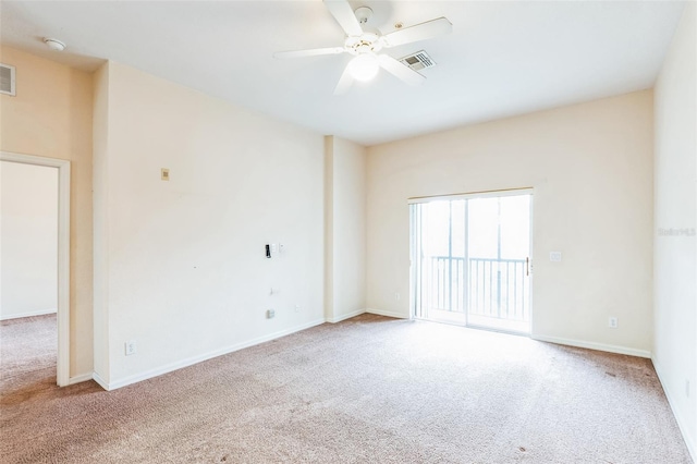 carpeted spare room featuring ceiling fan