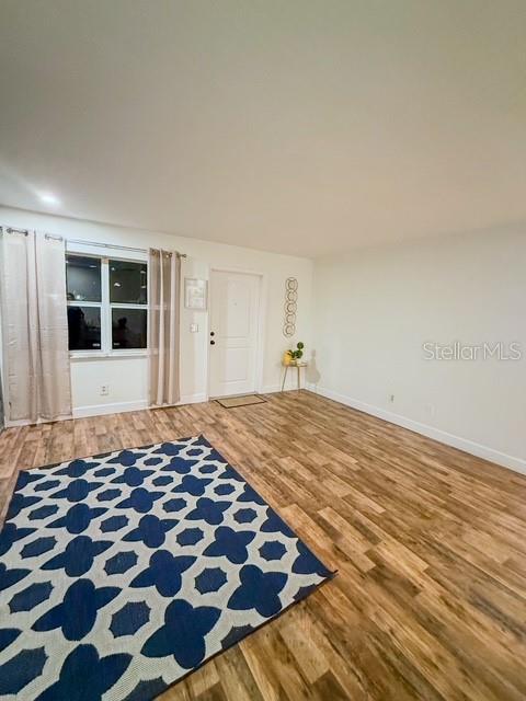 unfurnished living room featuring wood-type flooring