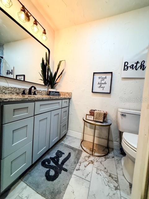 bathroom with vanity and toilet