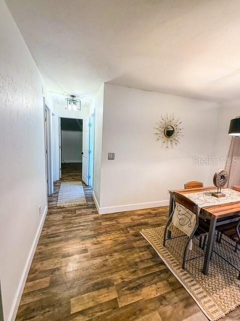 hallway with dark wood-type flooring