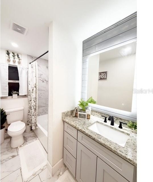 full bathroom featuring vanity, toilet, and shower / tub combo with curtain