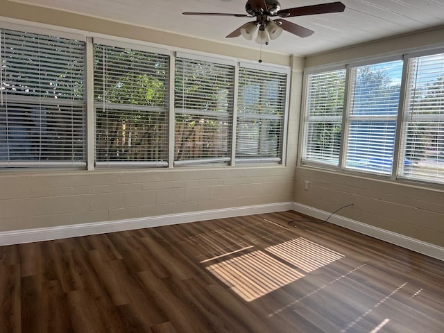 unfurnished sunroom featuring ceiling fan