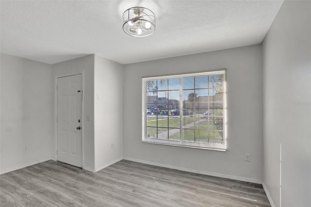 entrance foyer with a textured ceiling and light wood-type flooring